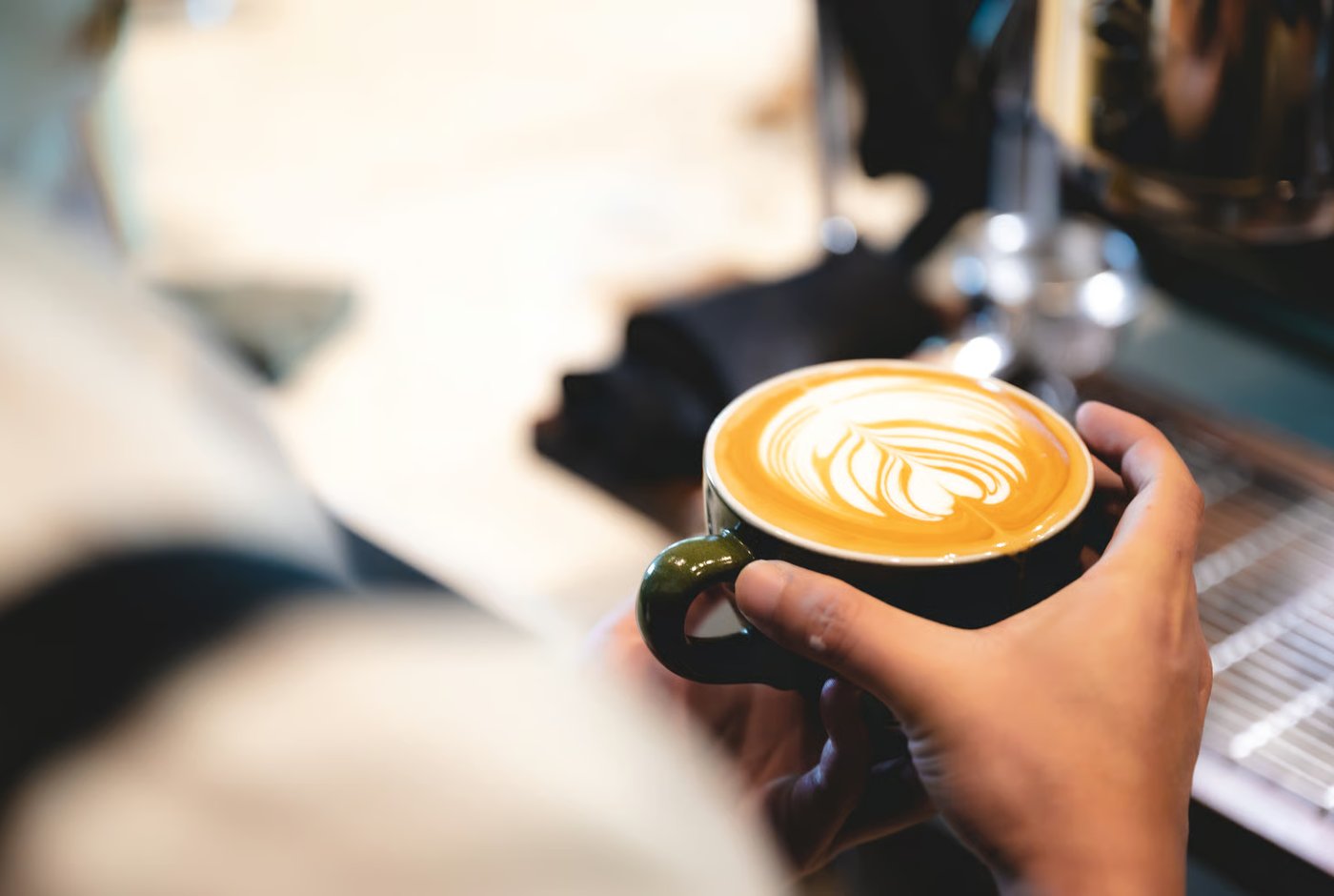 A finished latte handed across the bar.