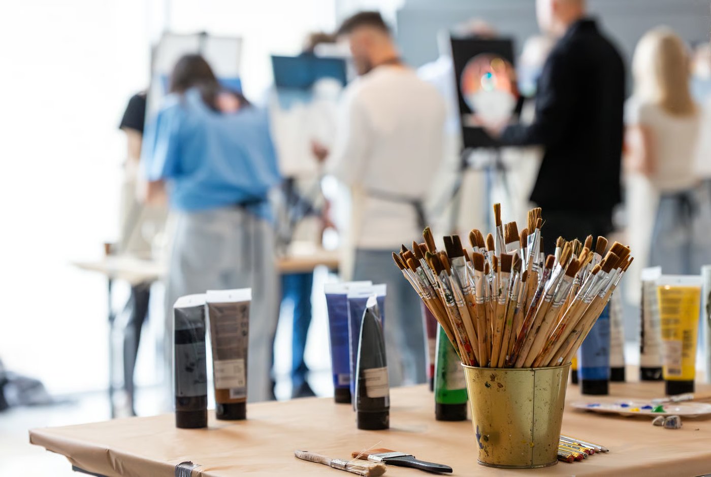 Paint tubes and brushes on the table during a painting afternoon.