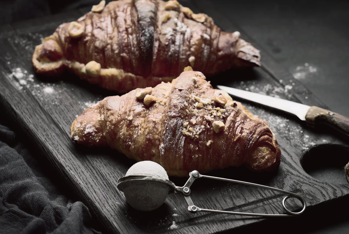 Croissants on a dark board.
