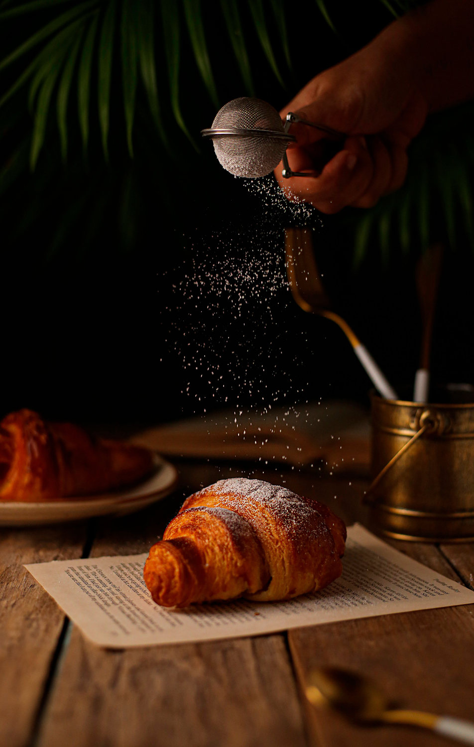 Sugar dusted over a croissant.